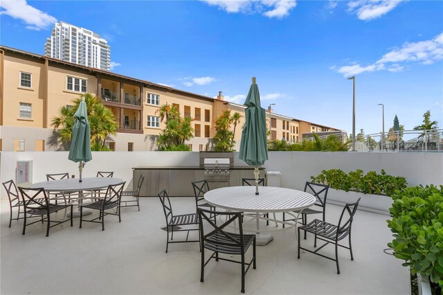 199 Dali Blvd Unit 2, Saint Petersburg, FL 33701 - view of patio featuring outdoor dining area, grilling area, and fence