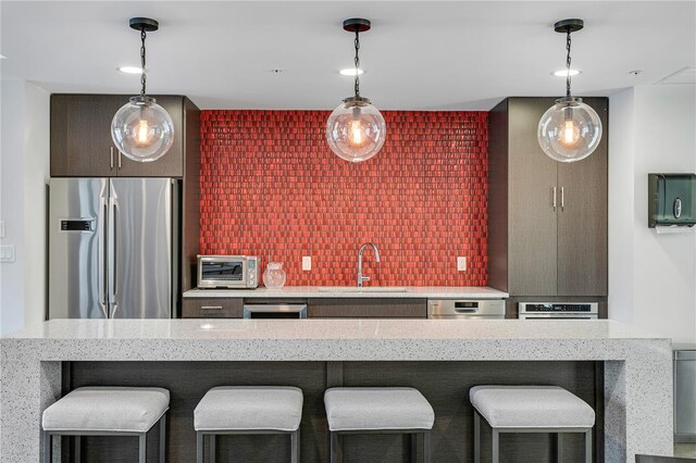 199 Dali Blvd Unit 2, Saint Petersburg, FL 33701 - kitchen with appliances with stainless steel finishes, a sink, a breakfast bar, and hanging light fixtures