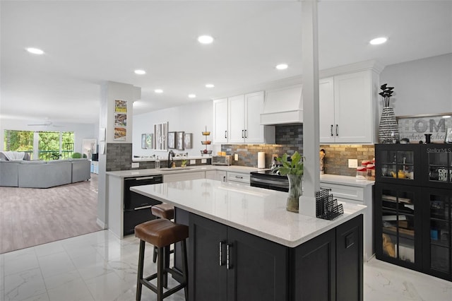 2533 Dolly Bay Dr Unit 203, Palm Harbor, FL 34684 - kitchen featuring custom exhaust hood, a sink, open floor plan, light marble finish floors, and recessed lighting