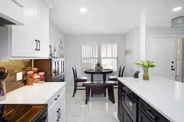 2533 Dolly Bay Dr Unit 203, Palm Harbor, FL 34684 - kitchen with black microwave, decorative backsplash, light countertops, white cabinetry, and recessed lighting