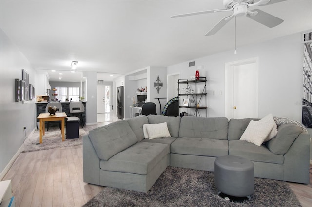 2533 Dolly Bay Dr Unit 203, Palm Harbor, FL 34684 - living area featuring light wood-style floors, ceiling fan, and baseboards