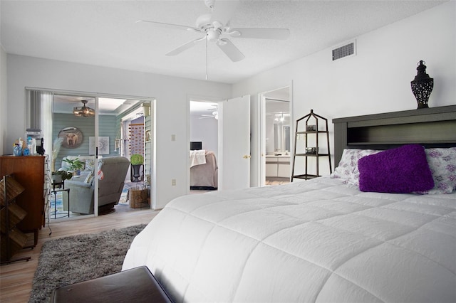 2533 Dolly Bay Dr Unit 203, Palm Harbor, FL 34684 - bedroom with wood finished floors, access to outside, a ceiling fan, and ensuite bathroom
