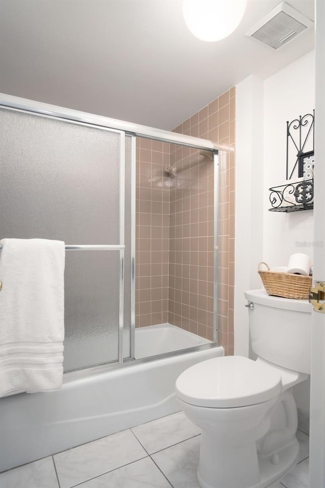 2533 Dolly Bay Dr Unit 203, Palm Harbor, FL 34684 - full bathroom featuring toilet, bath / shower combo with glass door, and tile patterned flooring