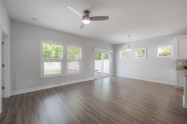 3906 N Lynn Ave, Tampa, FL 33603 - spare room with wood finished floors, ceiling fan, and baseboards