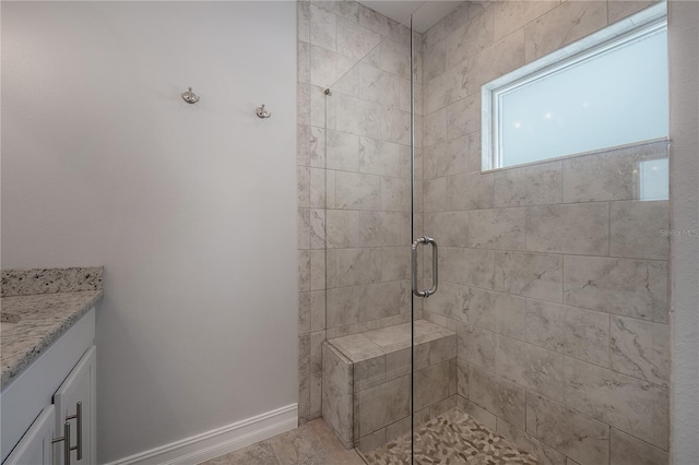 3906 N Lynn Ave, Tampa, FL 33603 - bathroom featuring a tile shower, vanity, and baseboards