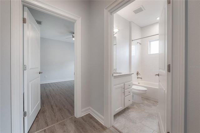 3906 N Lynn Ave, Tampa, FL 33603 - bathroom with vanity, a ceiling fan, shower / washtub combination, toilet, and wood finished floors