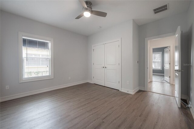 3906 N Lynn Ave, Tampa, FL 33603 - unfurnished bedroom with dark wood finished floors, a closet, baseboards, and a ceiling fan
