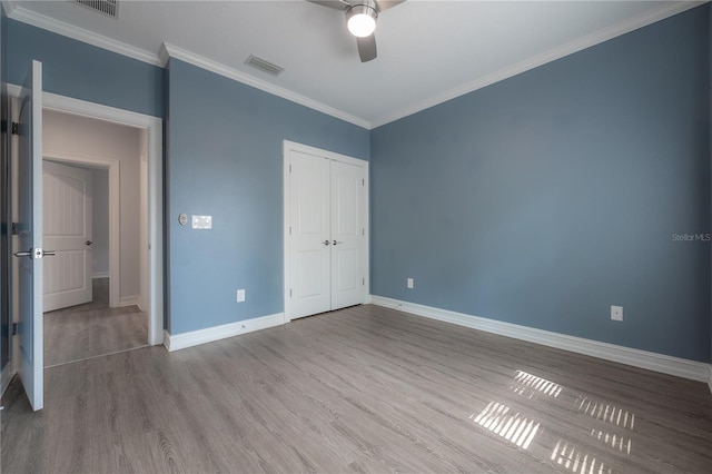 3906 N Lynn Ave, Tampa, FL 33603 - unfurnished bedroom with wood finished floors, baseboards, ornamental molding, a closet, and a ceiling fan