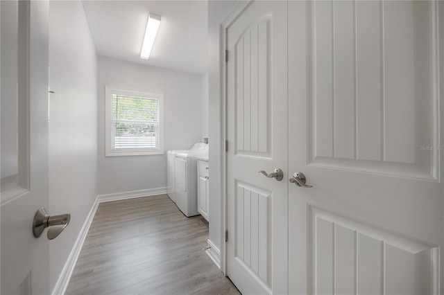 3906 N Lynn Ave, Tampa, FL 33603 - washroom with washing machine and clothes dryer, baseboards, and light wood-style floors