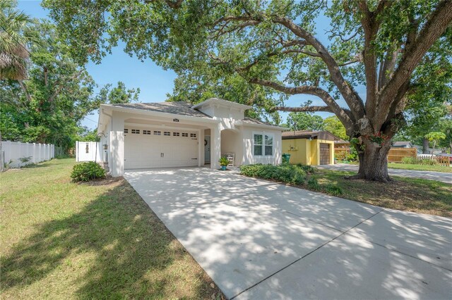 3906 N Lynn Ave, Tampa, FL 33603 - view of front facade featuring a garage, concrete driveway, and stucco siding