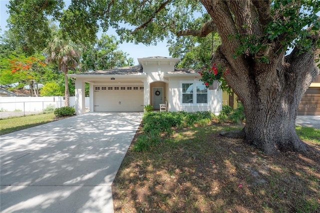 3906 N Lynn Ave, Tampa, FL 33603 - view of front of property with stucco siding, a garage, and concrete driveway