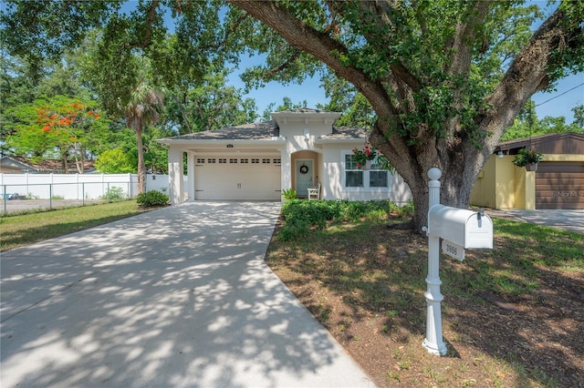 3906 N Lynn Ave, Tampa, FL 33603 - view of front of house with stucco siding, an attached garage, and driveway