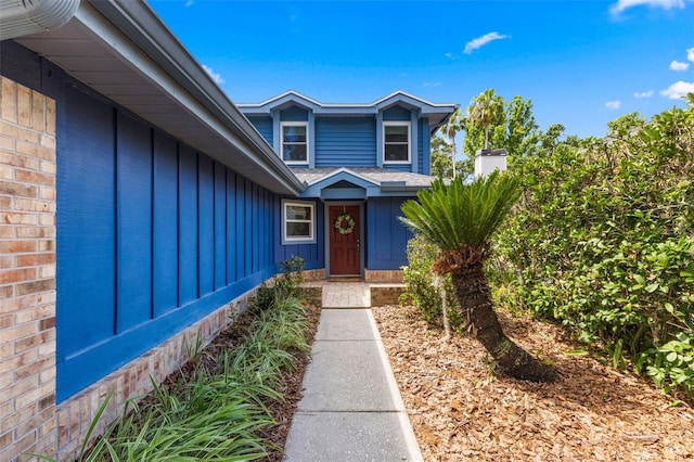 5032 Cypress Trace Dr, Tampa, FL 33624 - doorway to property with board and batten siding and a shingled roof