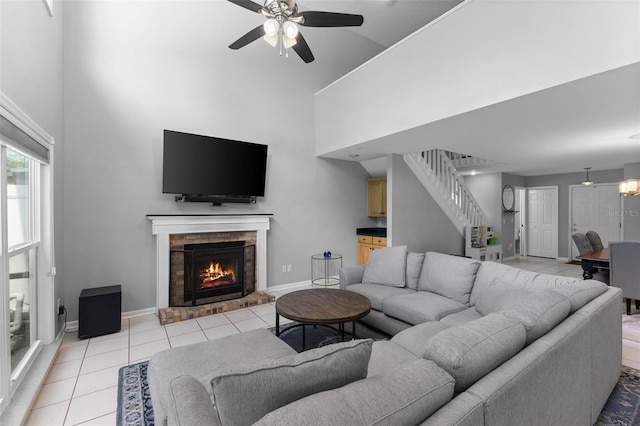 5032 Cypress Trace Dr, Tampa, FL 33624 - living room featuring a towering ceiling, stairs, ceiling fan, baseboards, and light tile patterned floors