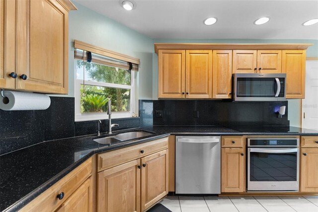 5032 Cypress Trace Dr, Tampa, FL 33624 - kitchen featuring stainless steel appliances, a sink, dark stone countertops, backsplash, and recessed lighting