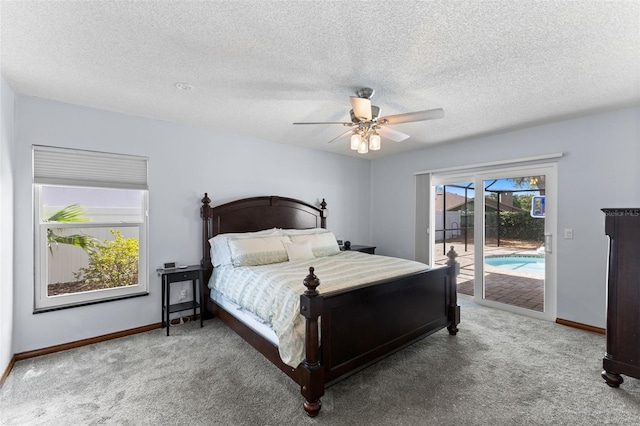 5032 Cypress Trace Dr, Tampa, FL 33624 - carpeted bedroom with access to exterior, baseboards, ceiling fan, and a textured ceiling