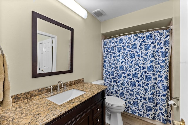 5032 Cypress Trace Dr, Tampa, FL 33624 - bathroom featuring toilet, vanity, and wood finished floors