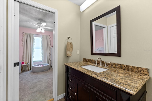 5032 Cypress Trace Dr, Tampa, FL 33624 - bathroom with a ceiling fan, vanity, and a textured ceiling