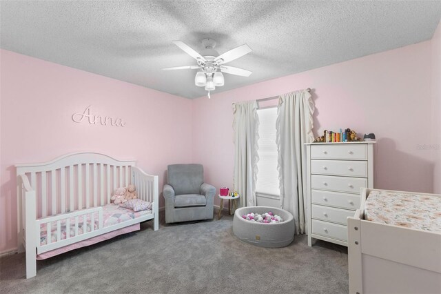 5032 Cypress Trace Dr, Tampa, FL 33624 - bedroom featuring carpet flooring, a nursery area, a textured ceiling, and ceiling fan