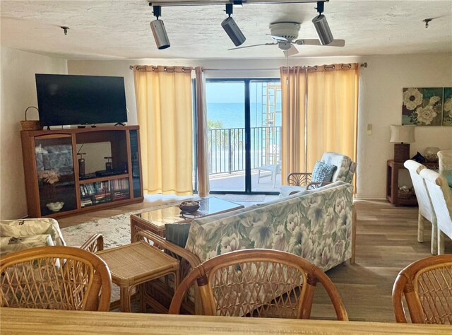 16330 Gulf Blvd Unit 201, Redington Beach, FL 33708 - living area featuring wood finished floors, a ceiling fan, and baseboards