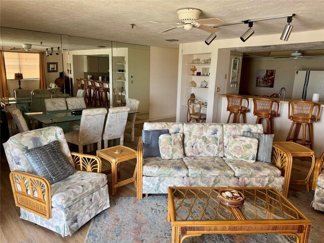 16330 Gulf Blvd Unit 201, Redington Beach, FL 33708 - living area with a ceiling fan, a textured ceiling, built in features, and wood finished floors