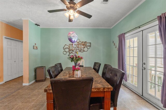 dining room with a textured ceiling, light tile patterned flooring, ceiling fan, french doors, and baseboards