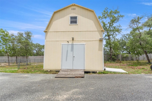 view of shed featuring fence