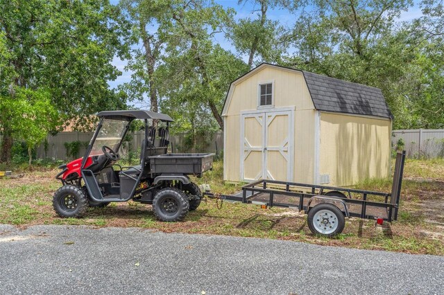 view of shed featuring fence