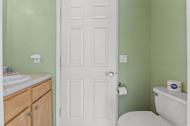 bathroom with toilet and vanity