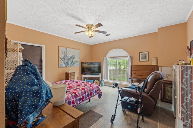 bedroom featuring a textured ceiling and ceiling fan