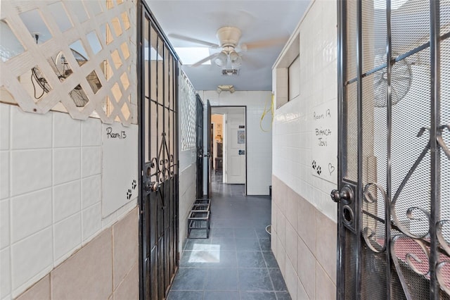 hallway with tile walls