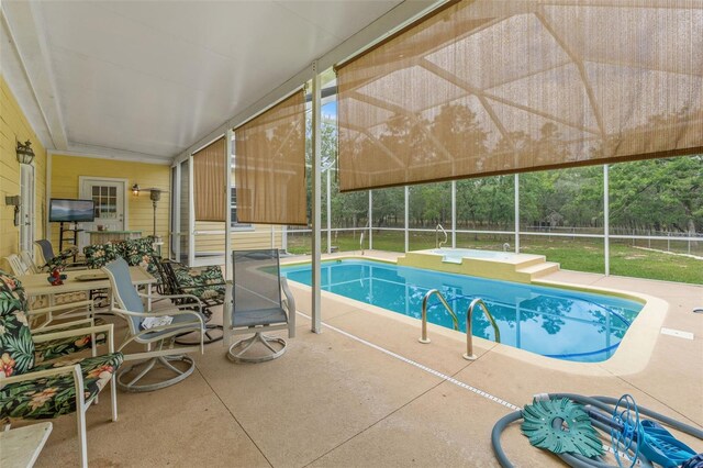 swimming pool featuring a patio, glass enclosure, and fence