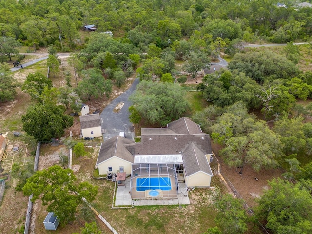 view of subject property with a pool area and a forest
