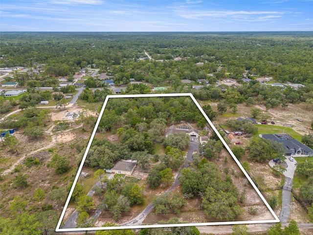 aerial overview of property's location featuring a heavily wooded area and property boundaries highlighted