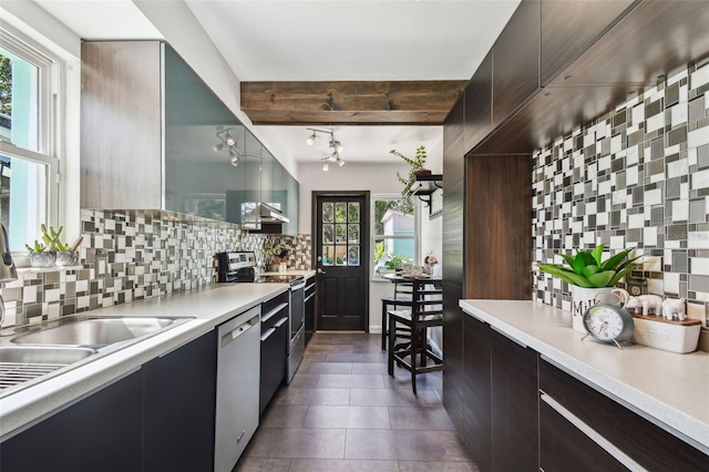 905 8th Ave SW, Largo, FL 33770 - kitchen with appliances with stainless steel finishes, backsplash, modern cabinets, light countertops, and dark tile patterned flooring