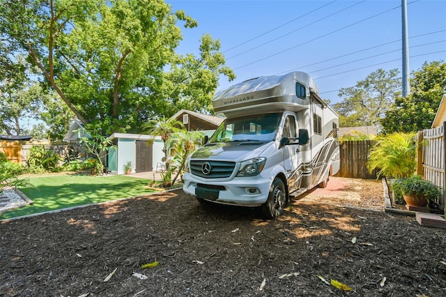 905 8th Ave SW, Largo, FL 33770 - view of car parking featuring a storage unit and a fenced backyard