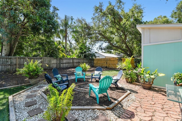 905 8th Ave SW, Largo, FL 33770 - fenced backyard with a fire pit and a patio