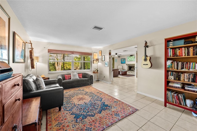 8083 Bayhaven Dr, Seminole, FL 33776 - living area featuring light tile patterned floors, baseboards, and a fireplace