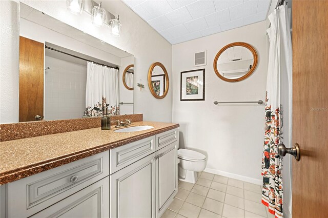 8083 Bayhaven Dr, Seminole, FL 33776 - bathroom with tile patterned flooring, toilet, and vanity