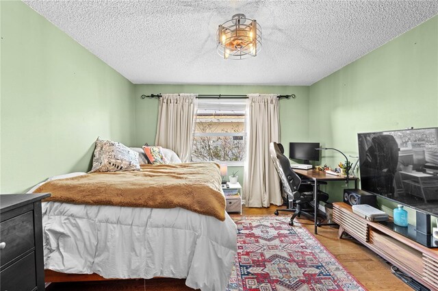 8083 Bayhaven Dr, Seminole, FL 33776 - bedroom featuring an office area, wood finished floors, and a textured ceiling