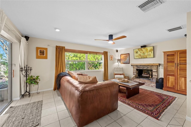 8083 Bayhaven Dr, Seminole, FL 33776 - living room with ceiling fan, a fireplace, light tile patterned floors, and baseboards