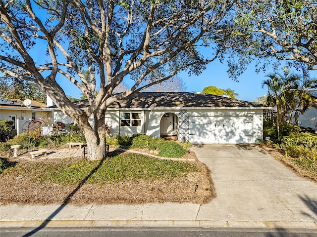 8083 Bayhaven Dr, Seminole, FL 33776 - ranch-style house with an attached garage and driveway