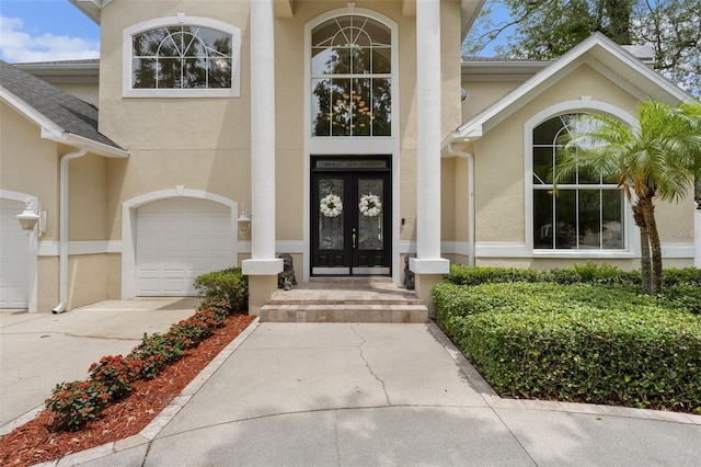 4515 W Leona St, Tampa, FL 33629 - property entrance featuring stucco siding, french doors, driveway, and an attached garage