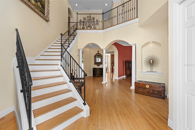 4515 W Leona St, Tampa, FL 33629 - entrance foyer with decorative columns, arched walkways, wood finished floors, a towering ceiling, and stairs