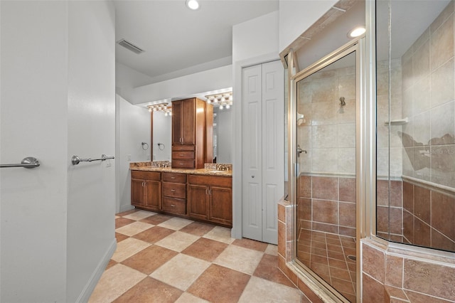 4515 W Leona St, Tampa, FL 33629 - bathroom featuring a shower stall, double vanity, recessed lighting, and tile patterned flooring