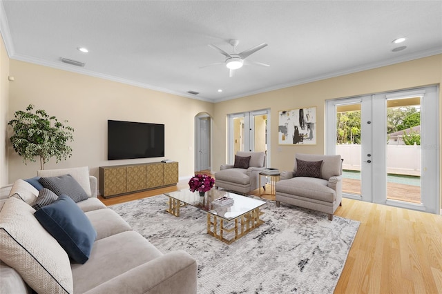 4515 W Leona St, Tampa, FL 33629 - living room featuring french doors, wood finished floors, arched walkways, a ceiling fan, and ornamental molding