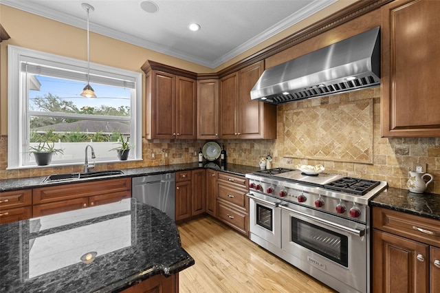 4515 W Leona St, Tampa, FL 33629 - kitchen featuring appliances with stainless steel finishes, wall chimney exhaust hood, crown molding, pendant lighting, and light wood finished floors