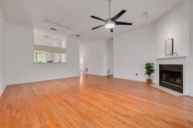 3044 Red Oak Ct Unit 204, Palm Harbor, FL 34684 - unfurnished living room with light wood-style flooring, a fireplace with flush hearth, a ceiling fan, crown molding, and track lighting