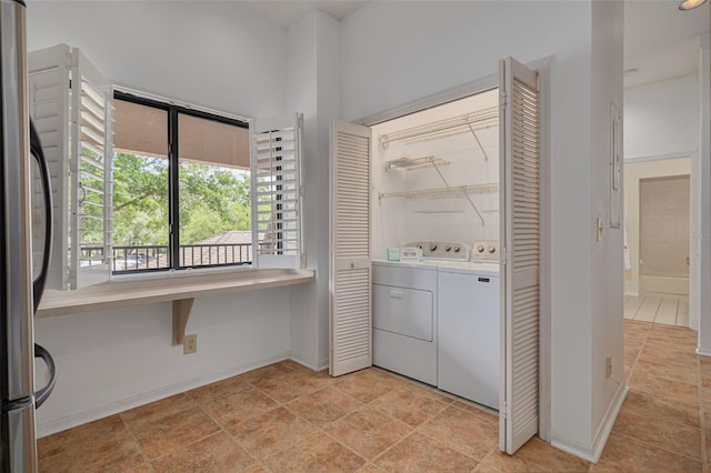 3044 Red Oak Ct Unit 204, Palm Harbor, FL 34684 - laundry area with baseboards and washer and dryer