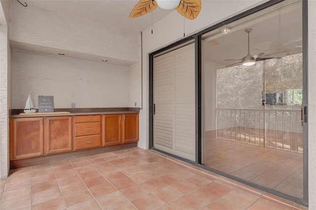 3044 Red Oak Ct Unit 204, Palm Harbor, FL 34684 - kitchen with ceiling fan, brown cabinets, and light tile patterned flooring